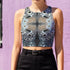 A women's sleeveless racerback crop top with a body-hugging fit. The top features a detailed, kaleidoscopic all-over print inspired by deer pelt. The symmetrical, Rorschach-like design includes abstract spots and textures in shades of brown, blue, black, and grey, creating an intricate pattern that resembles a deer pelt.